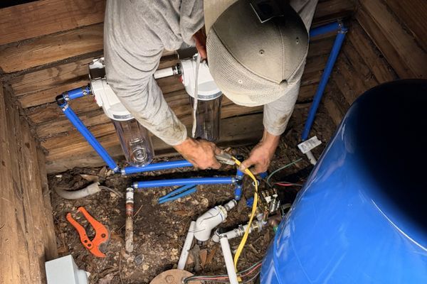 Employee repairing water heater