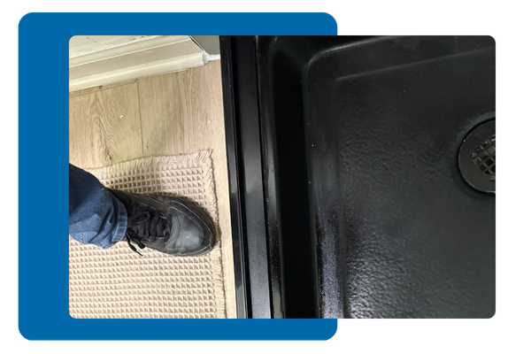 Person looking at shower drain