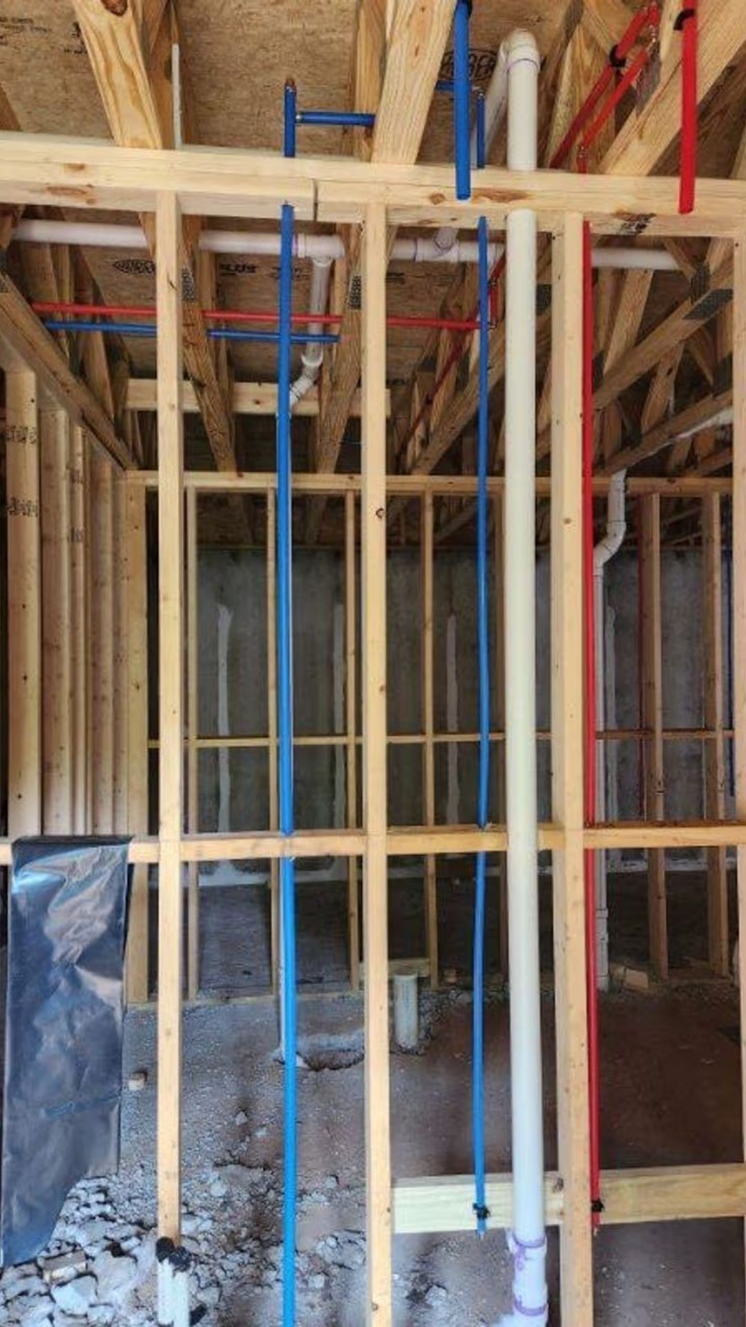 Pipes running down house framing