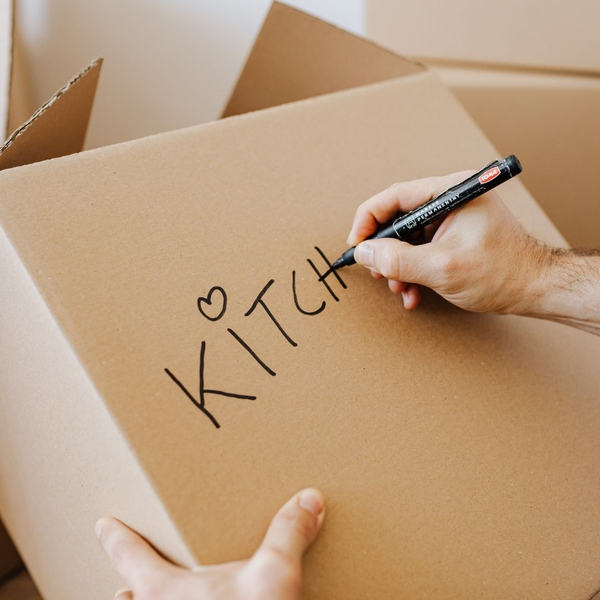a box being labeled kitchen 4 Essential Steps for a Smooth and Successful Move in Ocala (3).jpg