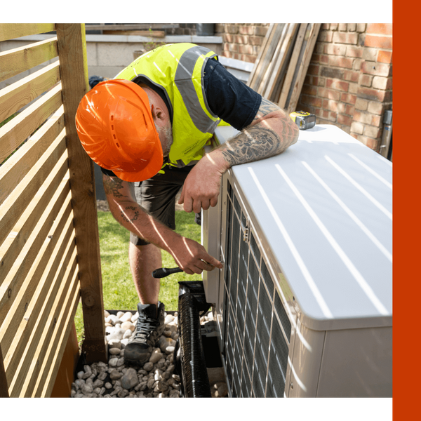 Image of a worker with an AC Unit Image of a worker with an AC Unit
