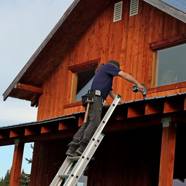 person installing a metal roof