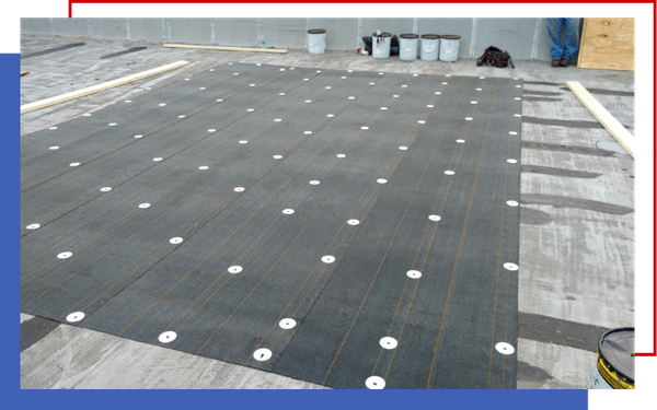 Roof leak repairs in progress on Commercial flat roof; roofing