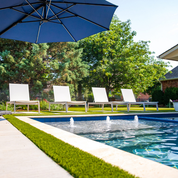 Four chairs next to a pool