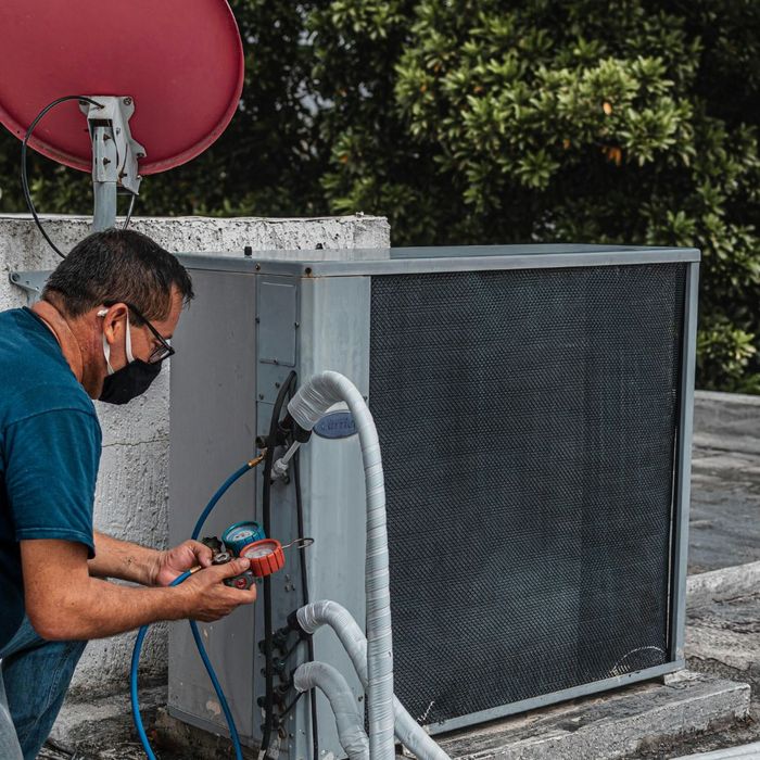 HVAC professional testing an AC unit