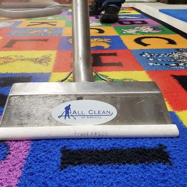 Using a steam cleaner on a kindergarten rug