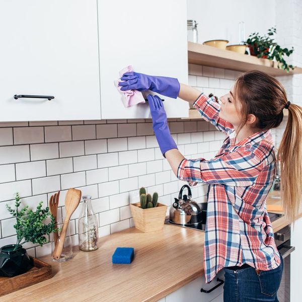 woman cleaning cabinet