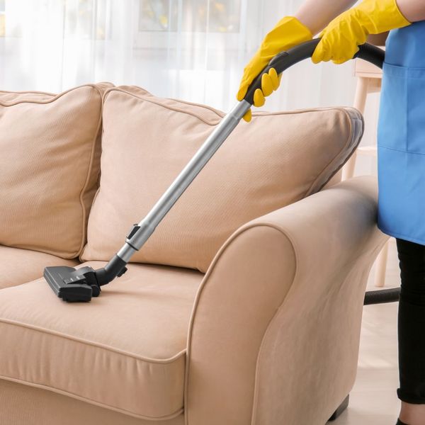 Professional cleaning a couch. 
