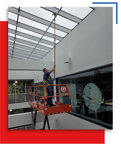 Washing interior windows on ceiling in commercial building