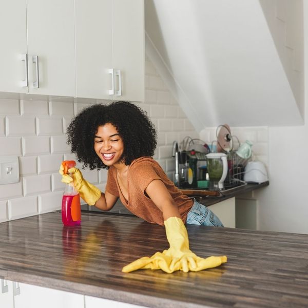 woman wipes down counter