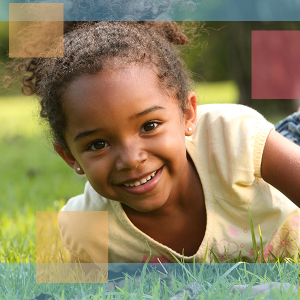 Little girl outside playing in grass