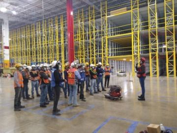 A group of construction workers in a warehouse