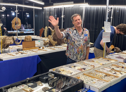 man waving at gem and mineral show