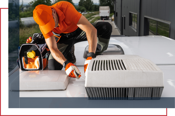 technician working on a rooftop ac installation for an RV