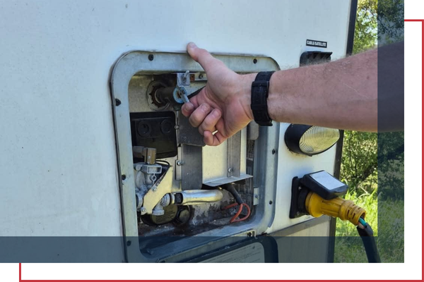 RV technician checking a tankless RV water heater RV technician checking a tankless RV water heater