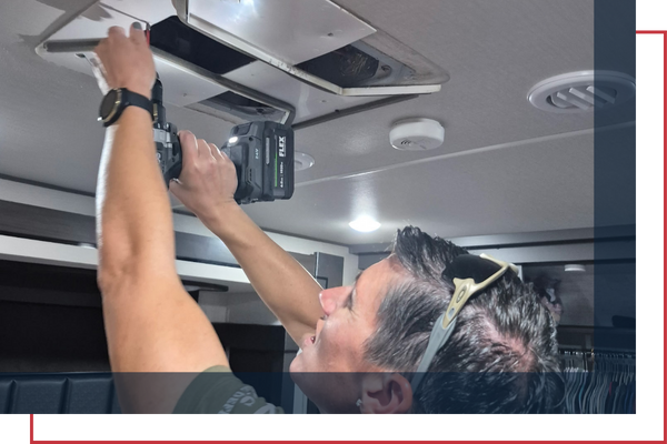certified RV technician finishing an ac installation