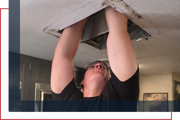technician fixing an ac unit duct in an RV