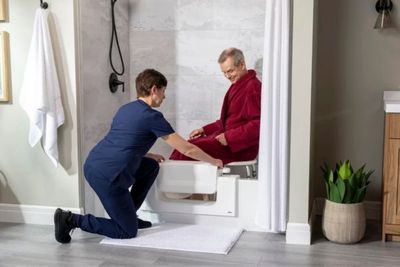 person installing step-in shower person installing step-in shower