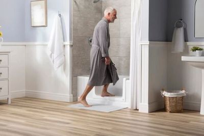 man using step-in shower man using step-in shower