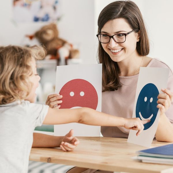 A speech therapist doing an exercise with a young boy A speech therapist doing an exercise with a young boy
