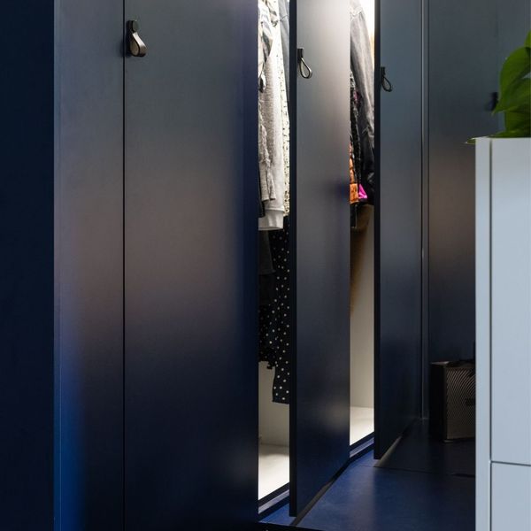 Clothes hanging in a cabinet 