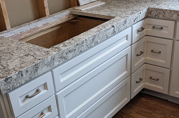 New white cabinets with marble counter top and gold hardware