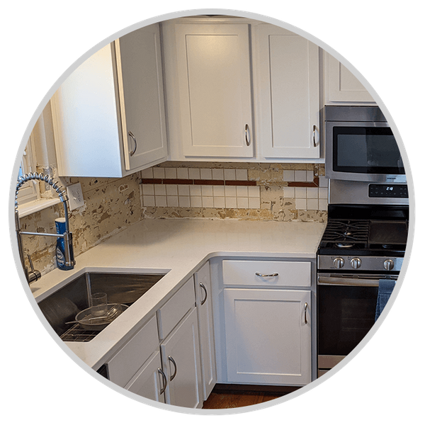 White cabinets with gold hardware in kitchen