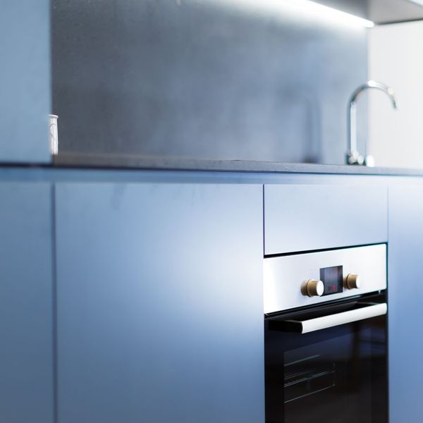 Flat panel cabinets next to a modern oven