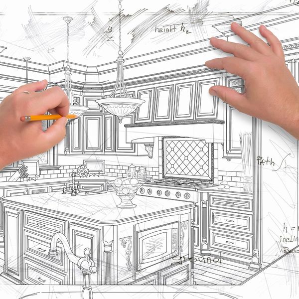 Person drawing custom kitchen cabinets. 