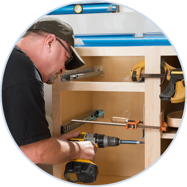 Man installing a wooden cabinet