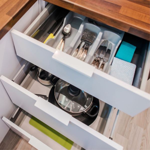 Cabinet drawers filled with neatly organized items. 