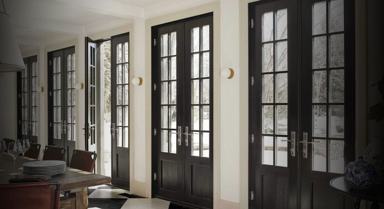 a wall of black double-doors with windows a wall of black double-doors with windows