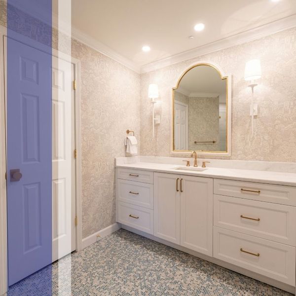 A modern white and gold bathroom vanity and cabinets