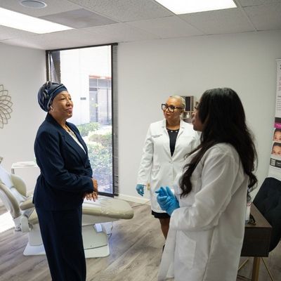 Women in white coats talking to client