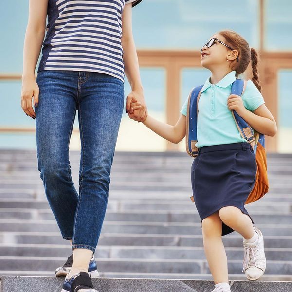 A parent walking their child to school