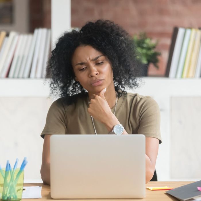 confused woman looking at computer