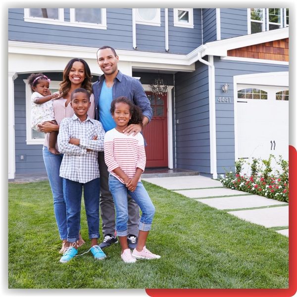 happy family in front of home