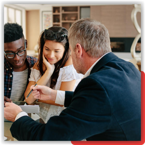 Couple looking over paperwork with a real estate agent