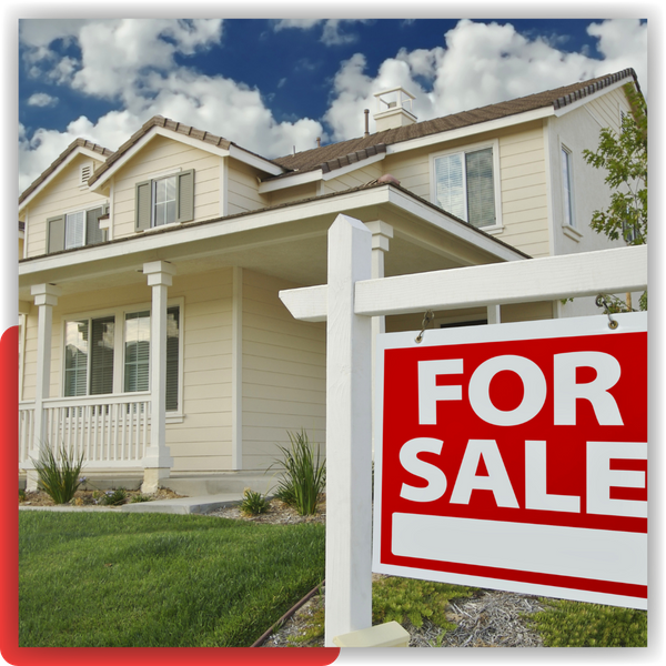 Home in front of a for sale sign