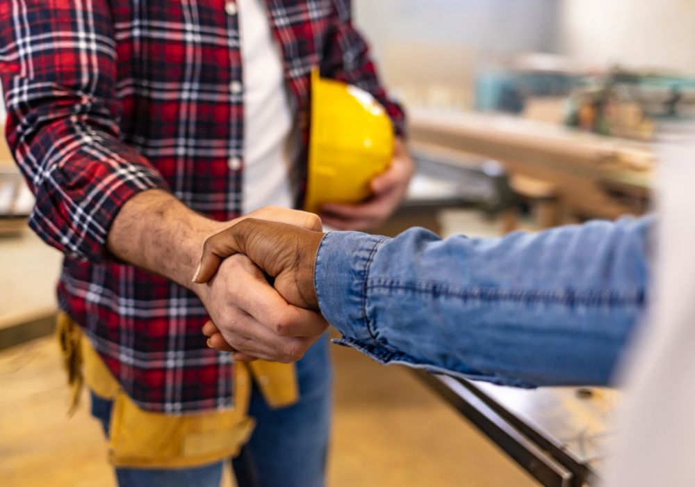 a contractor and client shaking hands