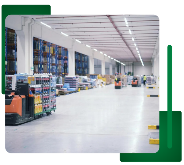 Wide shot of a clean warehouse/distribution center floor with product racks and forklifts.