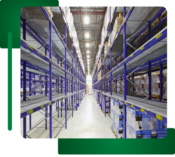 Aisle view of high shelves in a warehouse, brightly lit from above.