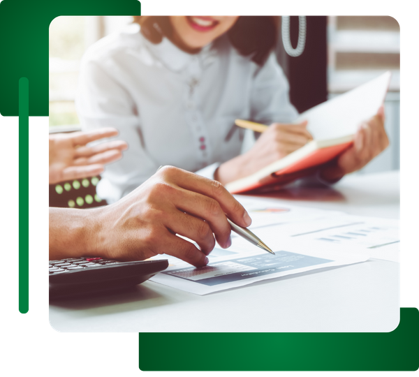 Close-up of people reviewing financial documents, calculator visible.