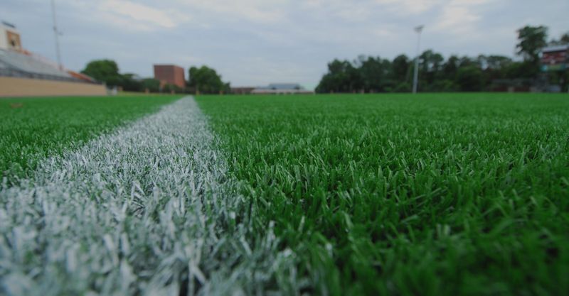 An image of a sports field made with artificial turf.