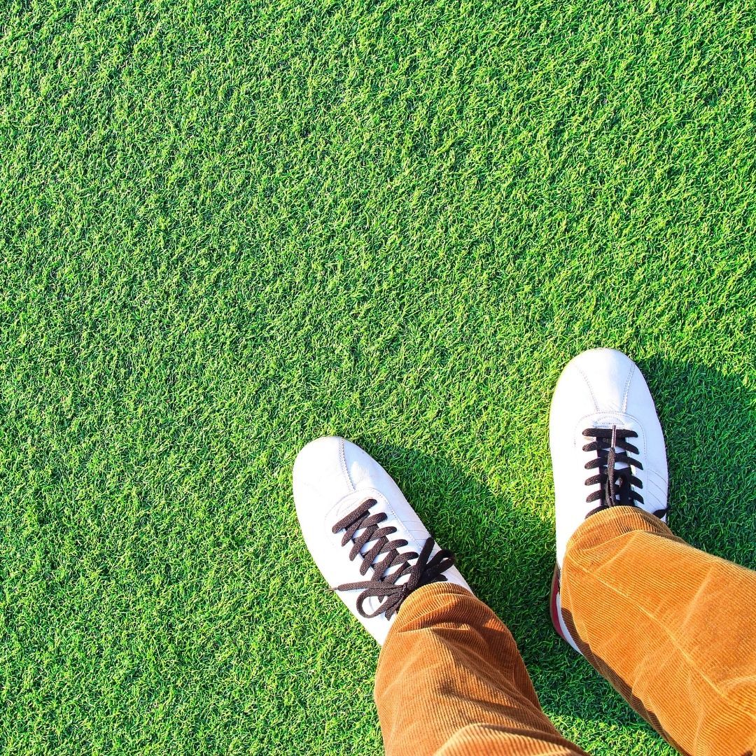 An image of someone standing on grass.