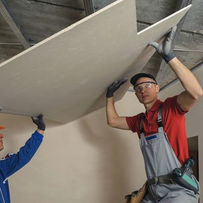 image of a man installing drywall