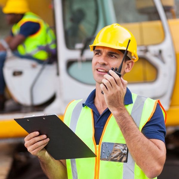 commercial inspection, man with clipboard at construction site