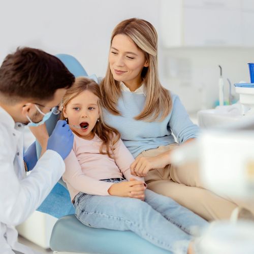 mother and young daughter at dentist office