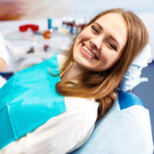 girl in dentist chair smiling