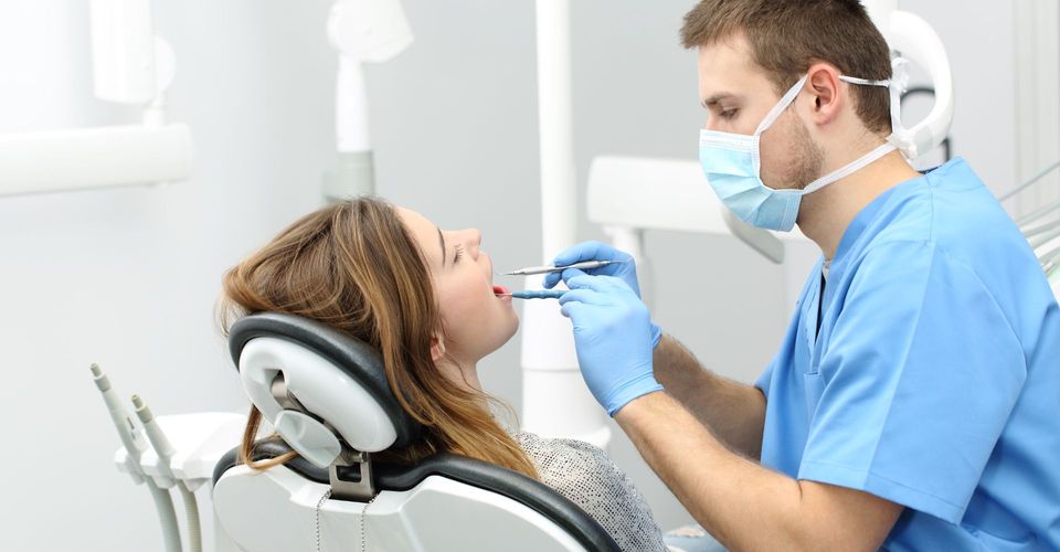 girl having her teeth examined